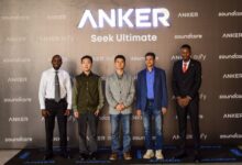 John Kiprotich, Anker Kenya Country Manager, stands with Anker executives in front of Anker, Soundcore and Eufy branding during the Kenya launch event in Nairobi.