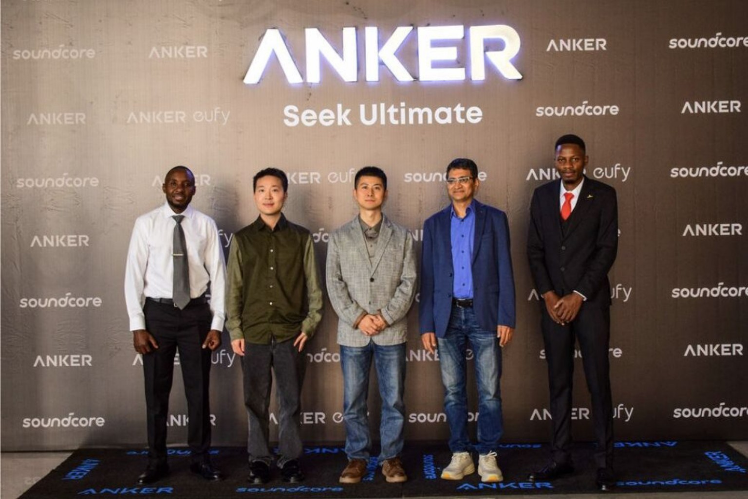 John Kiprotich, Anker Kenya Country Manager, stands with Anker executives in front of Anker, Soundcore and Eufy branding during the Kenya launch event in Nairobi.