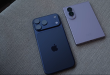 Apple iPhone 17 Pro beside a Samsung Galaxy Z Fold8 on a fabric surface, illustrating competition between iPhone and Android flagships.