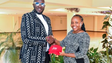 Thomas Kwaka Omolo and Hildah Maina hold a .ke branded cap during a KeNIC event promoting Kenya's local domain registrations.