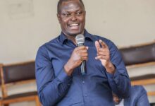 Kiharu MP Ndindi Nyoro speaking into a microphone during a public address on Kenya's banking sector.