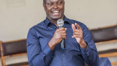 Kiharu MP Ndindi Nyoro speaking into a microphone during a public address on Kenya's banking sector.