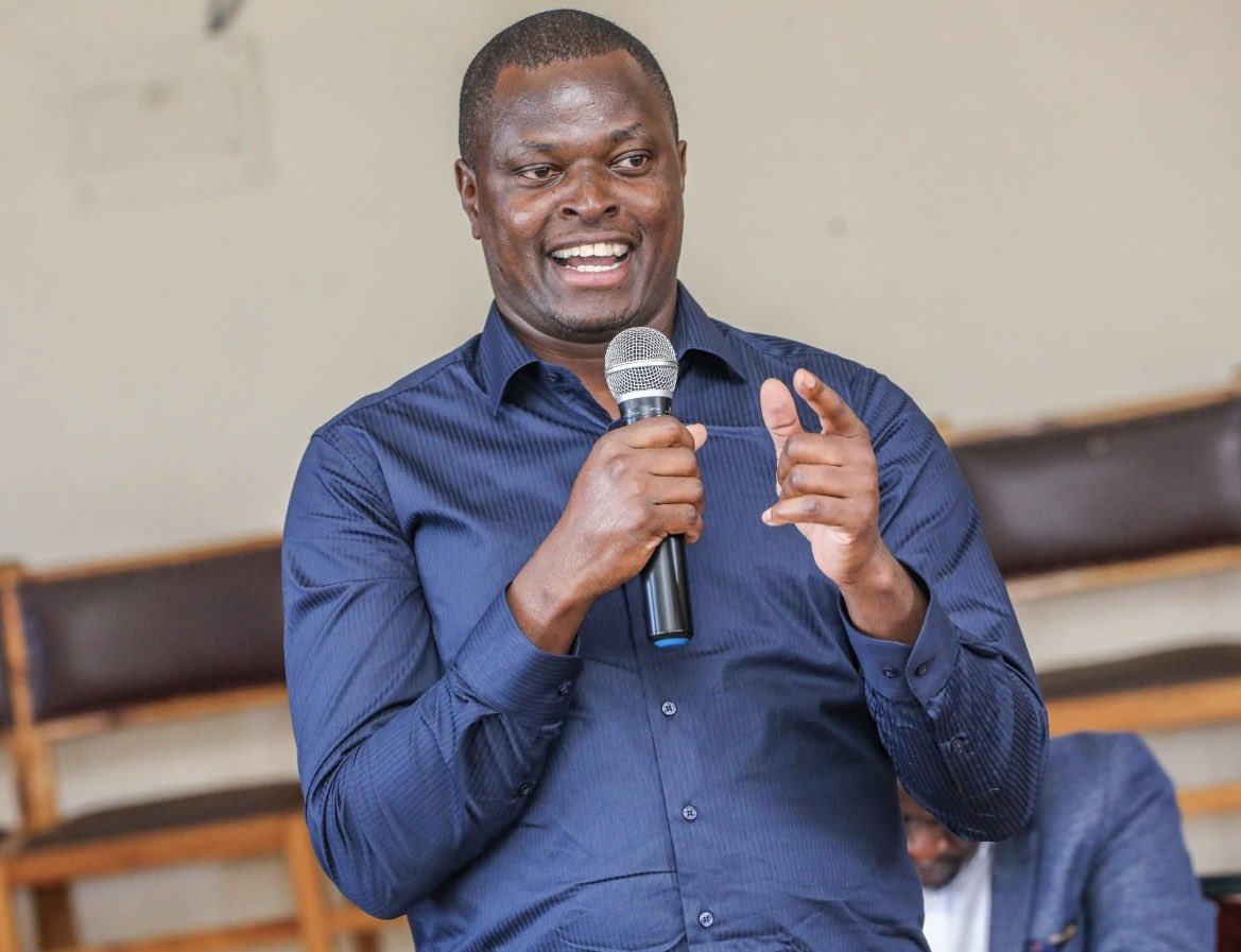 Kiharu MP Ndindi Nyoro speaking into a microphone during a public address on Kenya's banking sector.
