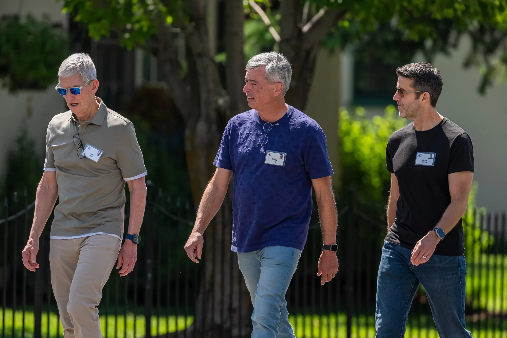 Tim Cook, Eddy Cue and John Ternus walking together at Apple