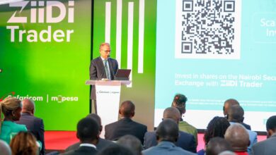 Safaricom Chief Financial Officer Dilip Pal speaks at the ZiiDi Trader launch event at the Nairobi Securities Exchange with ZiiDi Trader branding displayed behind him.