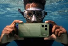 Promotional image showing the green itel Power 80 submerged underwater in a diver's hands, illustrating the device's water-resistant design and rugged positioning.