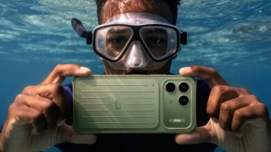 Promotional image showing the green itel Power 80 submerged underwater in a diver's hands, illustrating the device's water-resistant design and rugged positioning.