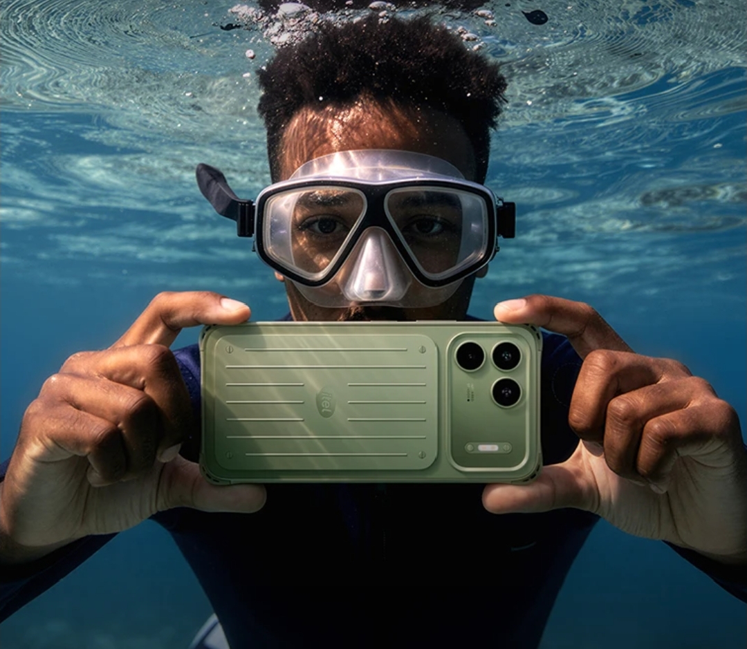 Promotional image showing the green itel Power 80 submerged underwater in a diver's hands, illustrating the device's water-resistant design and rugged positioning.
