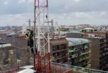 Technician installing Taara wireless optical communication equipment on a telecom tower in Lagos, Nigeria.