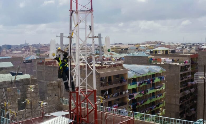 Technician installing Taara wireless optical communication equipment on a telecom tower in Lagos, Nigeria.