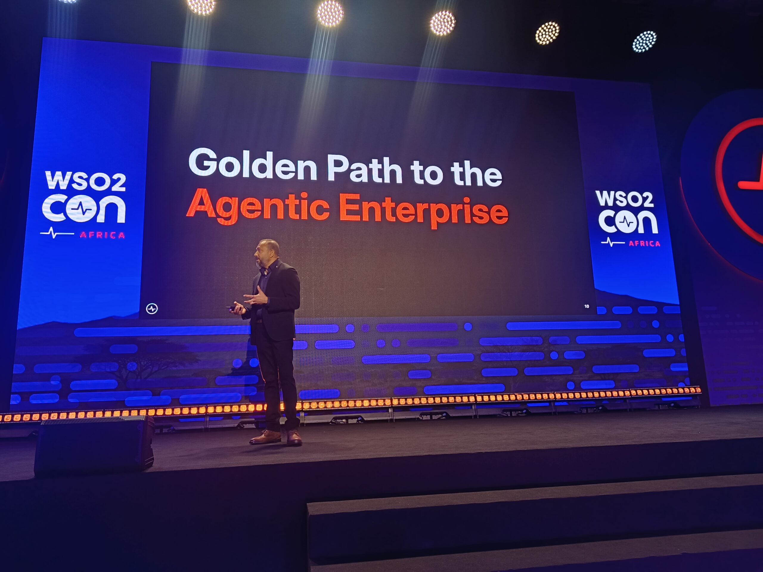 Asanka Abeysinghe delivering a keynote presentation titled "Golden Path to the Agentic Enterprise" on stage at WSO2Con Africa in Nairobi.