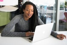 Kenyan businesswoman using a laptop for digital business banking with Equity Online for Business