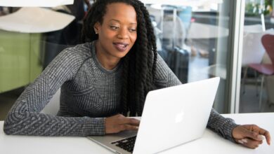 Kenyan businesswoman using a laptop for digital business banking with Equity Online for Business
