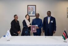 Kenya's William Kabogo Gitau hands the signed Digital Cooperation Organization Charter to Secretary-General Deemah AlYahya in New York