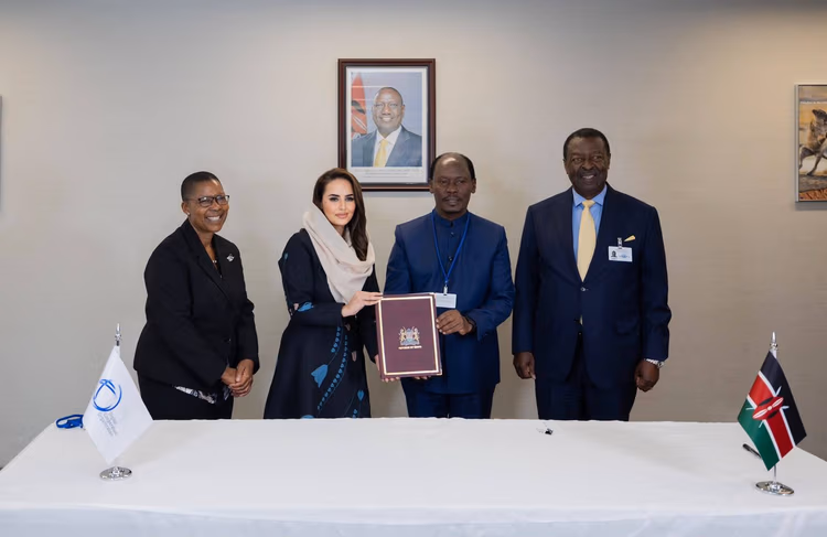 Kenya's William Kabogo Gitau hands the signed Digital Cooperation Organization Charter to Secretary-General Deemah AlYahya in New York
