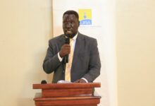 Uganda Revenue Authority official speaking at a tax compliance engagement