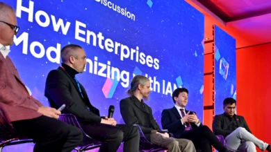 Panel discussion at WSO2Con featuring speakers on stage during an enterprise technology conference