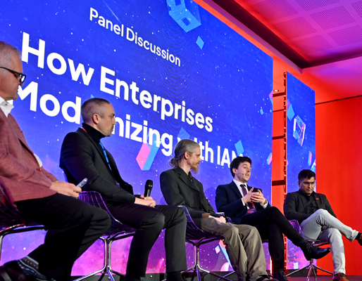 Panel discussion at WSO2Con featuring speakers on stage during an enterprise technology conference
