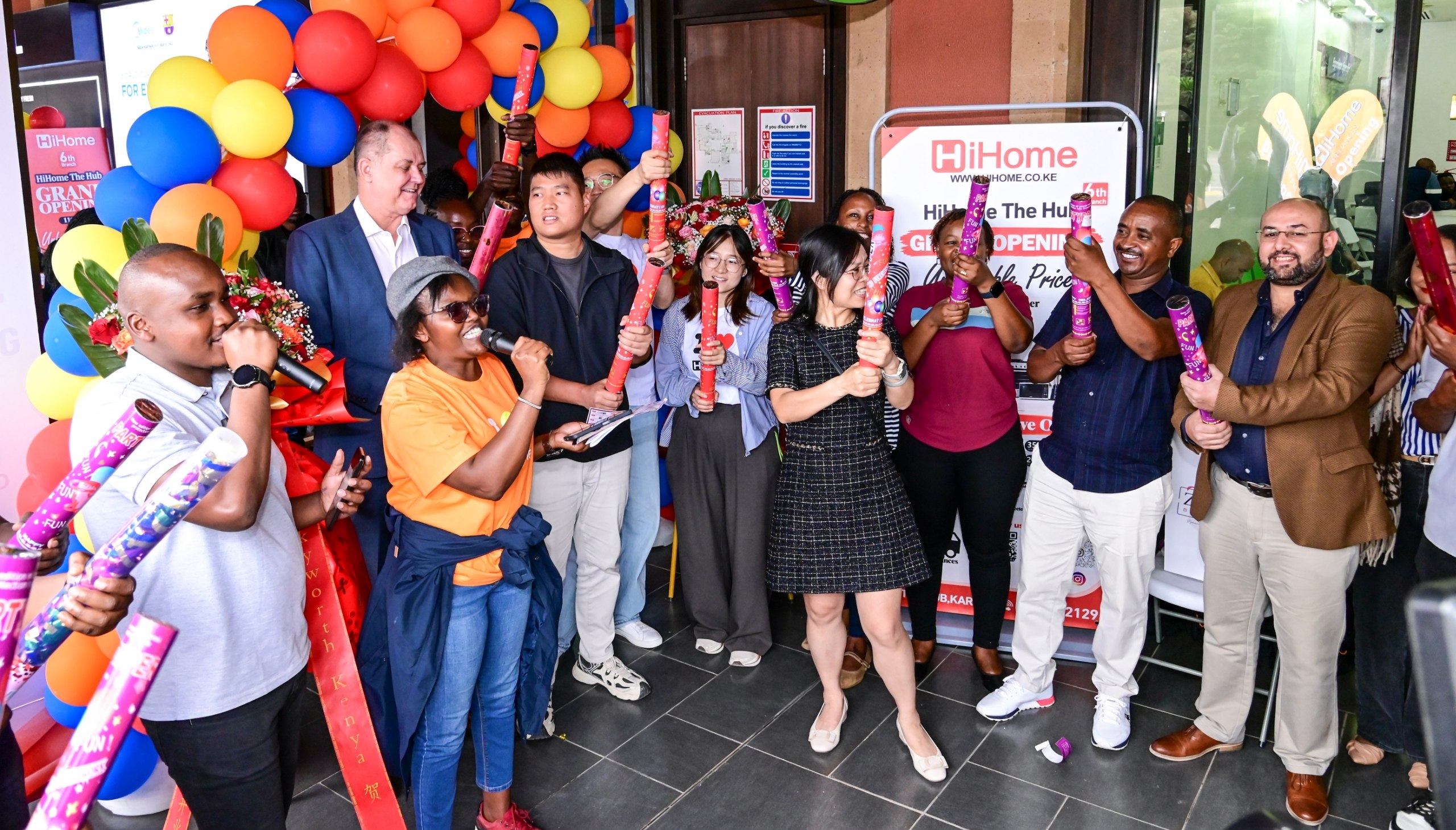 HiHome store management, staff, and The Hub Karen Mall Manager Jacobus Visser popping party poppers during the grand opening ribbon-cutting event at The Hub Karen.