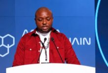 Kelechi Uchegbulam, CEO of Passpoint, speaking at a podium during his keynote address at the Africa Blockchain Festival 2026 in Nairobi.