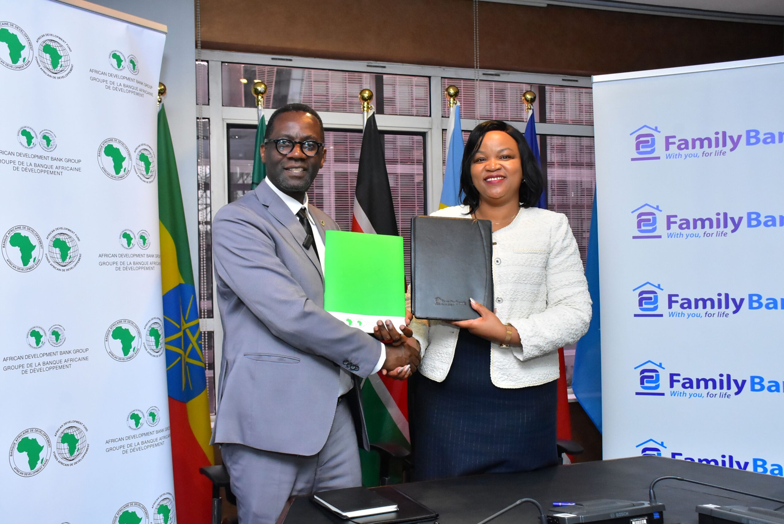 AfDB East Africa Director General Dr. Alex Mubiru and Family Bank CEO Nancy Njau sign $10M trade finance facility agreement.